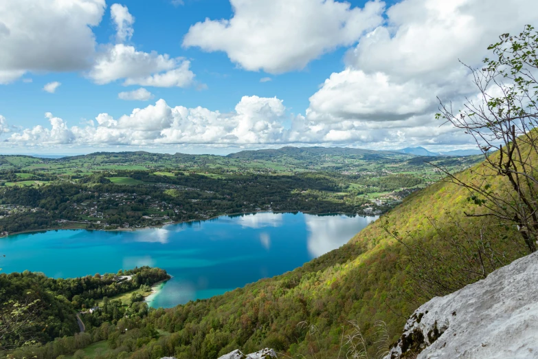 the mountains are near a lake that is surrounded by grassy terrain