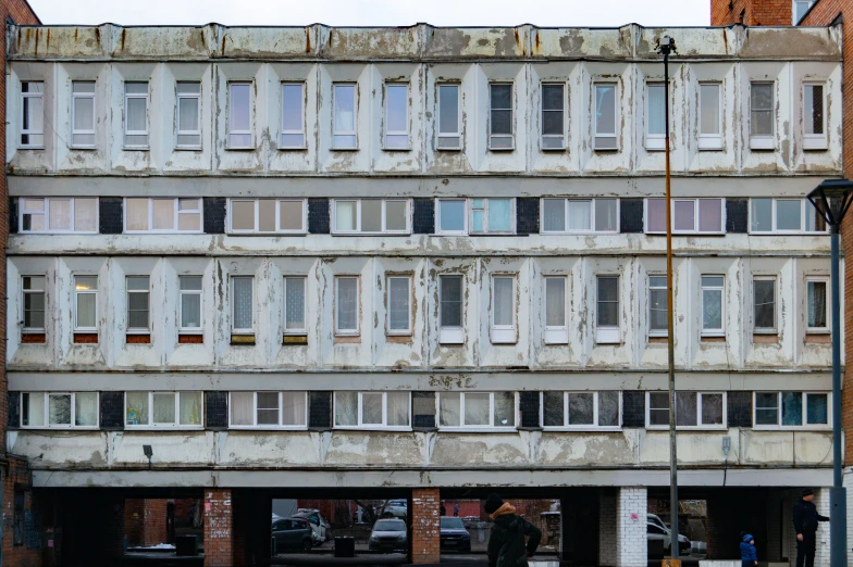 an old building that is holding cars parked