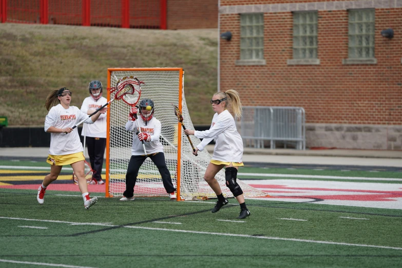 a group of young people playing a game of lacrosse