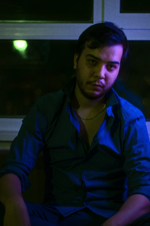 a man is sitting with his feet up on the edge of the desk