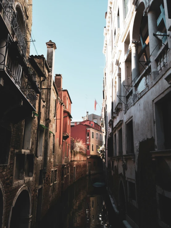 an old canal runs down a small city street