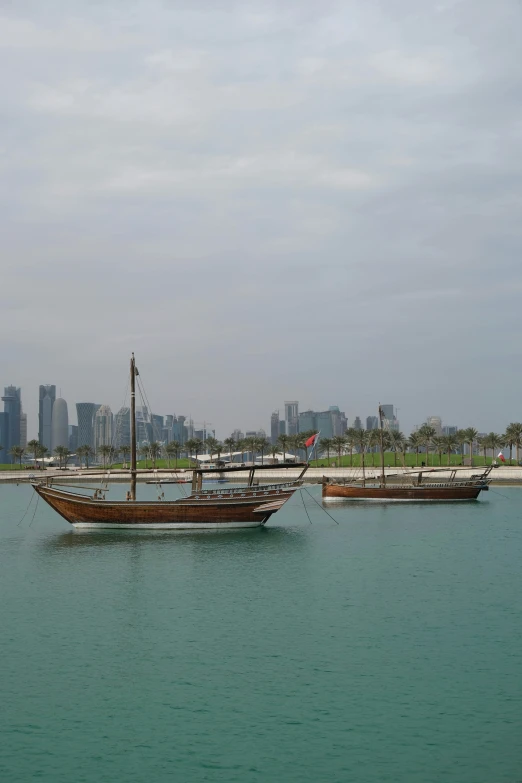 two large boats floating across the water