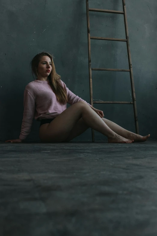 a girl sitting with her legs crossed posing for the camera