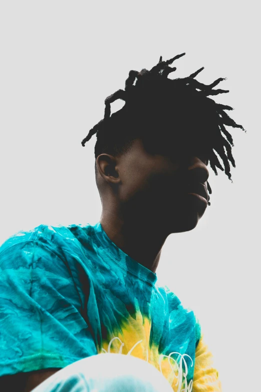 a man with dread locks on his hair sitting