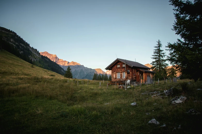 the house is surrounded by a mountain range