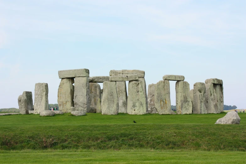 several large stonehenges stand in the grass