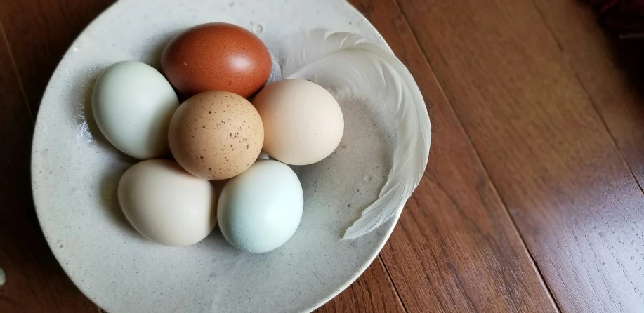 four eggs sit on top of one another on a plate