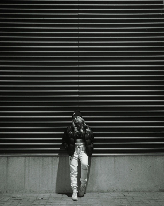 black and white po of a man lying on the sidewalk