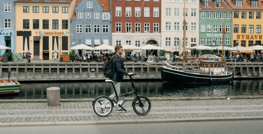 the man is riding his bicycle near the waterfront