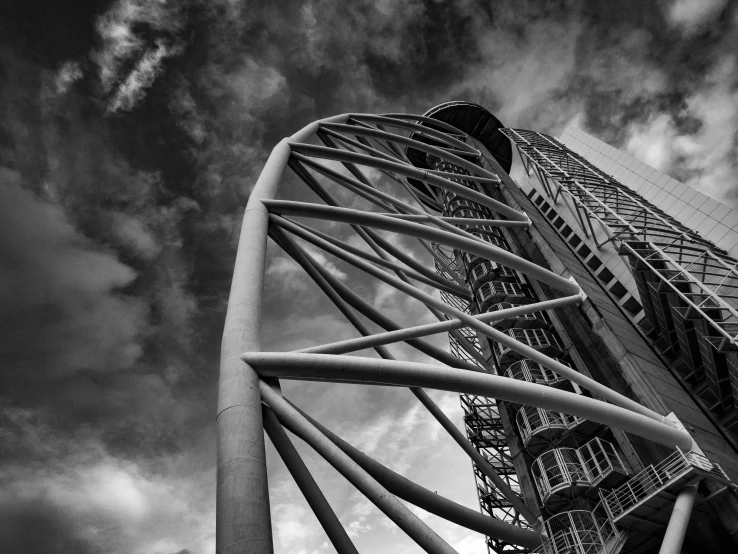 a tall ferris wheel in front of a cloudy sky