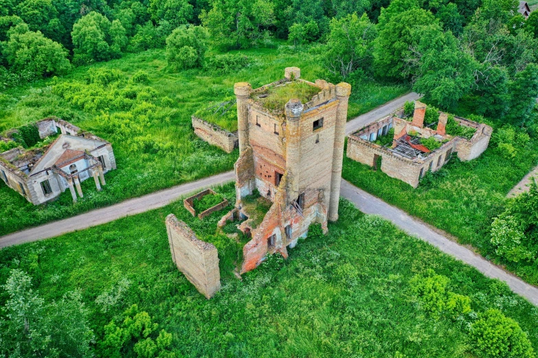 an old castle sits in the middle of some green trees