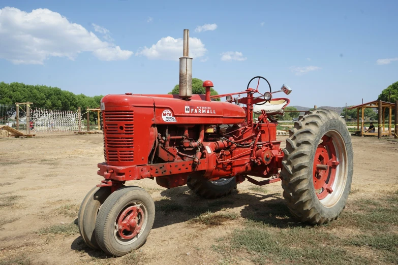 a red tractor in the middle of a field