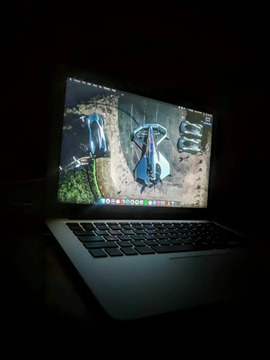 a laptop on a desk in the dark