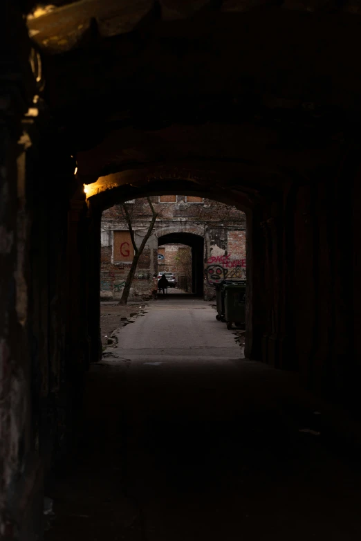 a view looking into an alley way and dark lighting