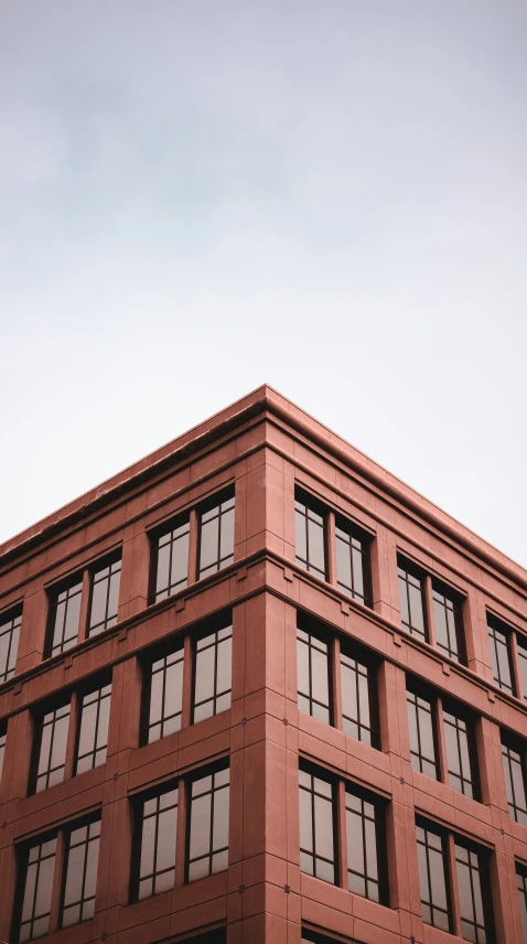 an old - fashioned brick building with several windows on top