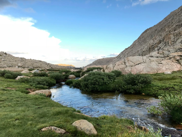 there is a beautiful stream running between two mountain peaks