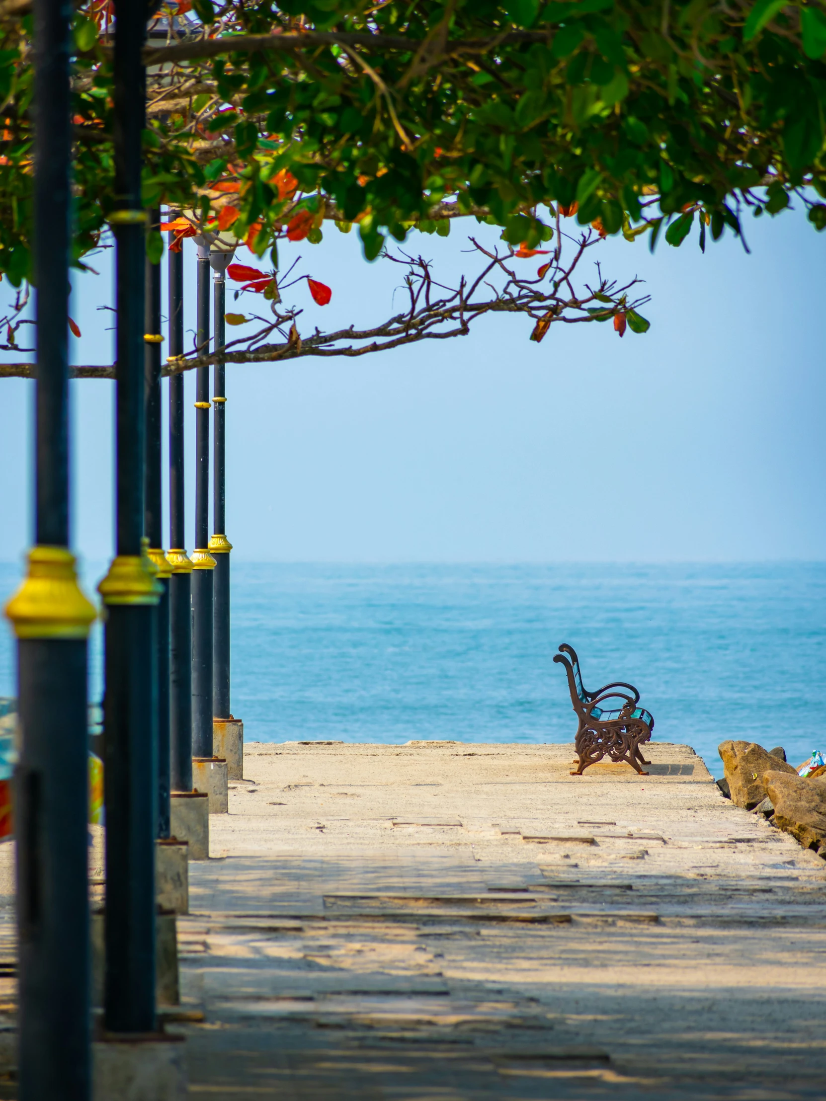 an old bicycle sitting in the sand under an umbrella