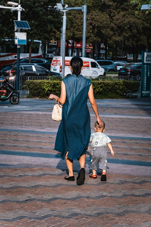 a mother and son walking in the city