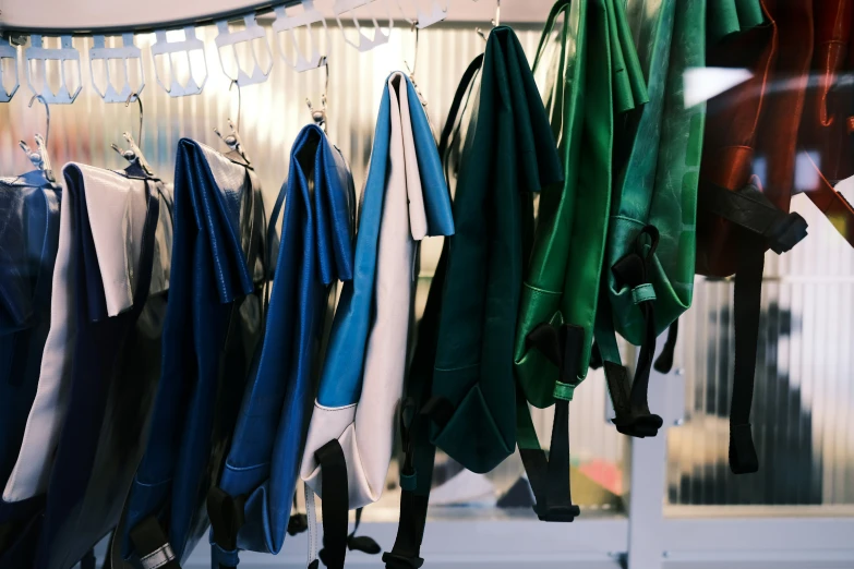 multiple shirts hung on a wall with clothes hung on them