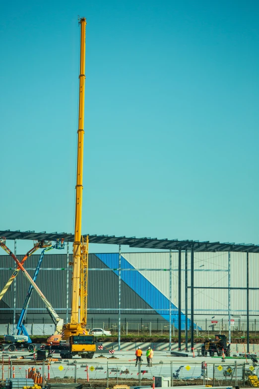 cranes are set up outside an airport terminal