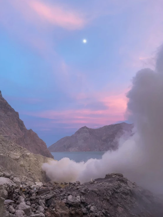 steam rises from a crater in a desert