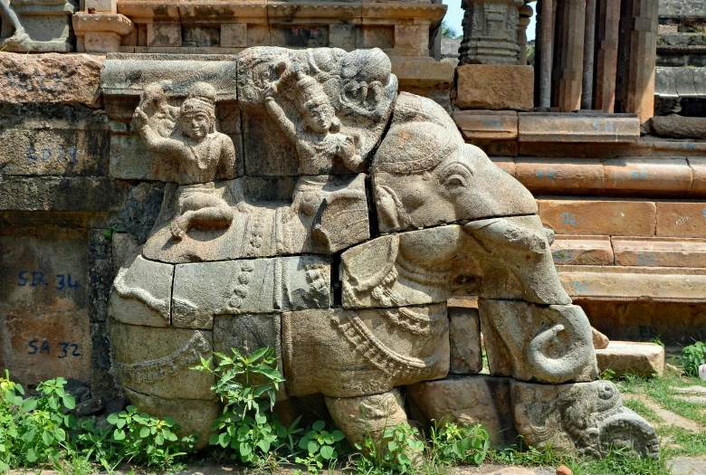 some stone carvings are next to steps in the park