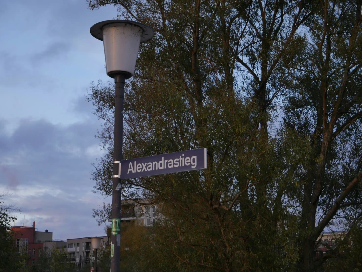 an empty street sign under a blue and cloudy sky