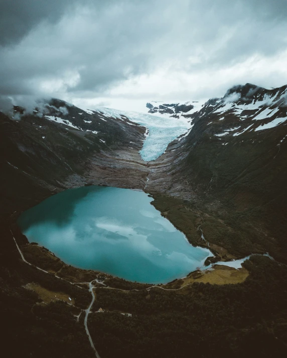 the large mountain side has a very big pond in it