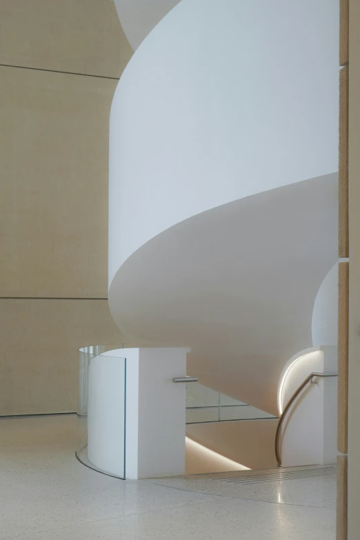 the stair in the building is curved white