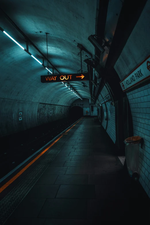 a subway station with a dark subway and the light on