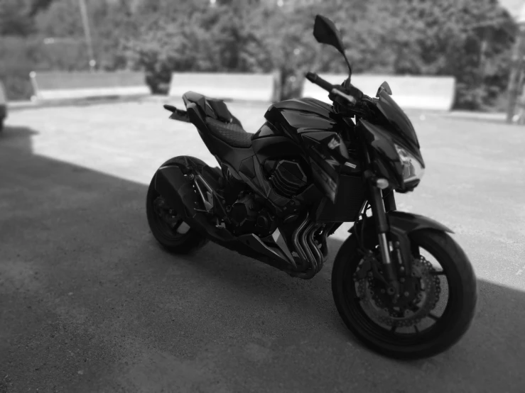 a close up of a motorcycle parked on a sidewalk