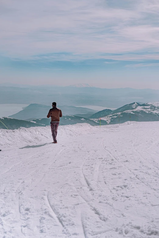 a man walks in the snow with an outfit on