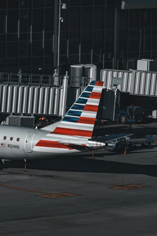 an american airlines passenger jet is parked at a terminal