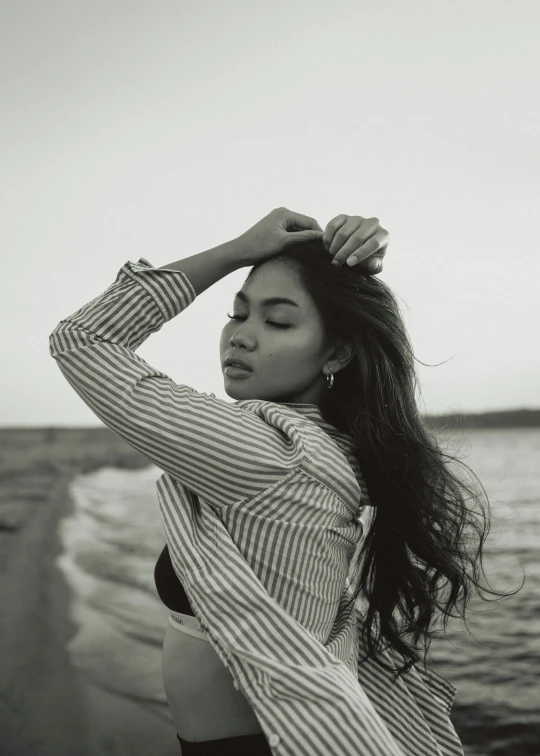 black and white pograph of a woman standing next to water