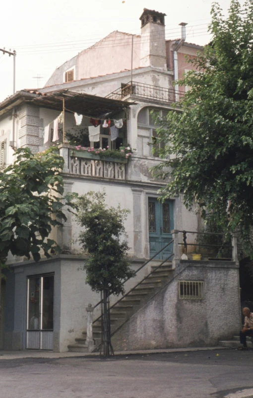 an old house with a balcony and stairs