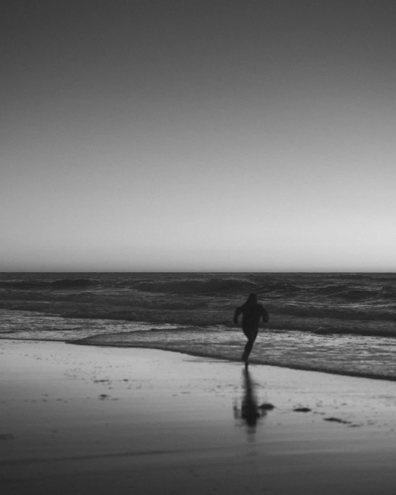 a person standing on a beach with an umbrella