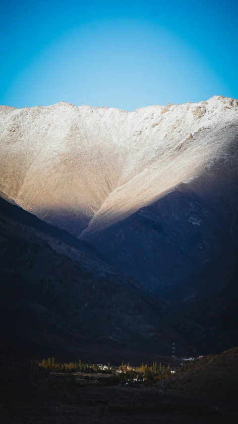 some mountains with some snow on them and blue sky