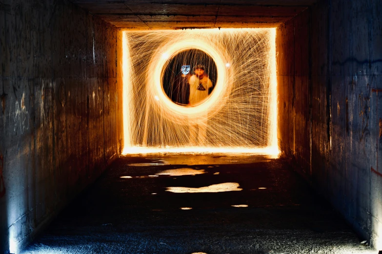 a woman is looking into a tunnel with some lights on it