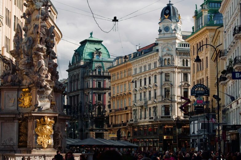 a busy street with people walking and some buildings