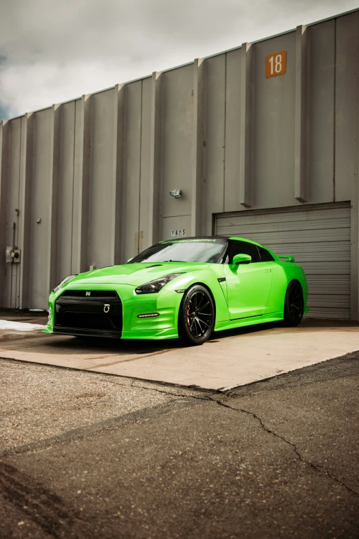 a green car parked in front of a building