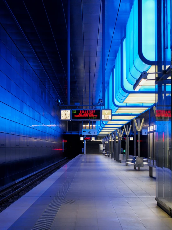 a subway station with bright blue lights in it