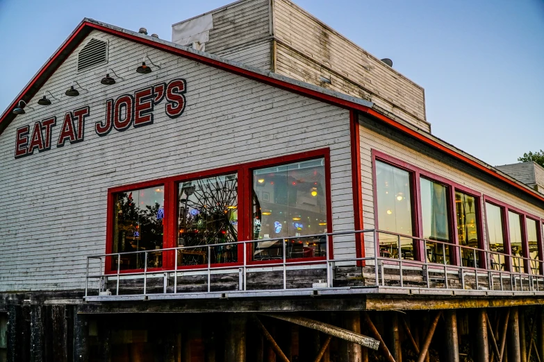 the front view of an old restaurant with its red door