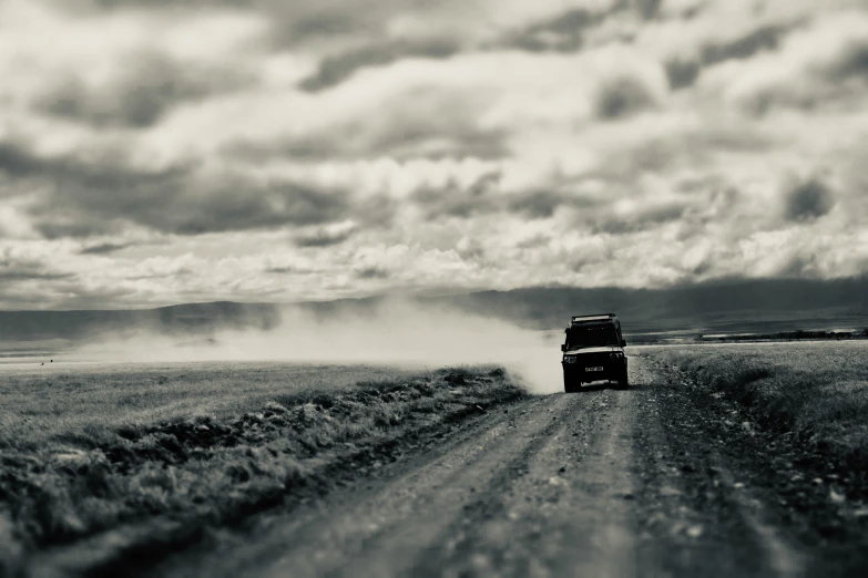 a truck is on a dirt road in the middle of nowhere