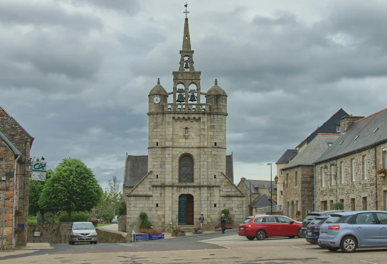 a church with tall steeple surrounded by smaller buildings