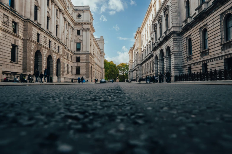 street view of a row of buildings and street with pedestrians