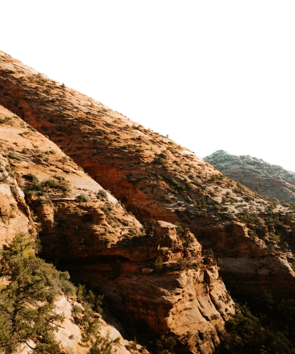 a person climbing up the side of a mountain