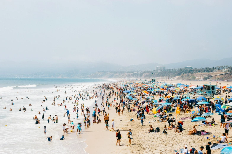 the crowded beach has people on it