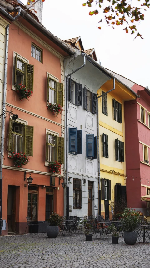 a couple of buildings with some flowers in the windows