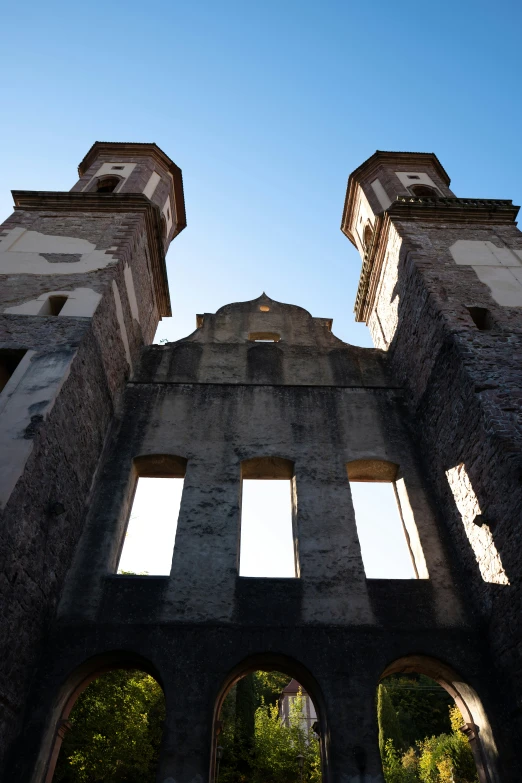 a close - up view of an abandoned brick building with windows