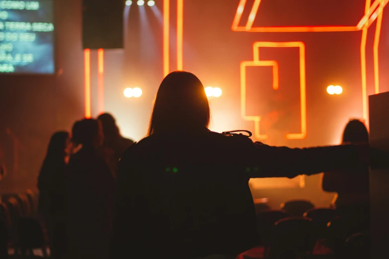 people at a concert, some holding onto a screen